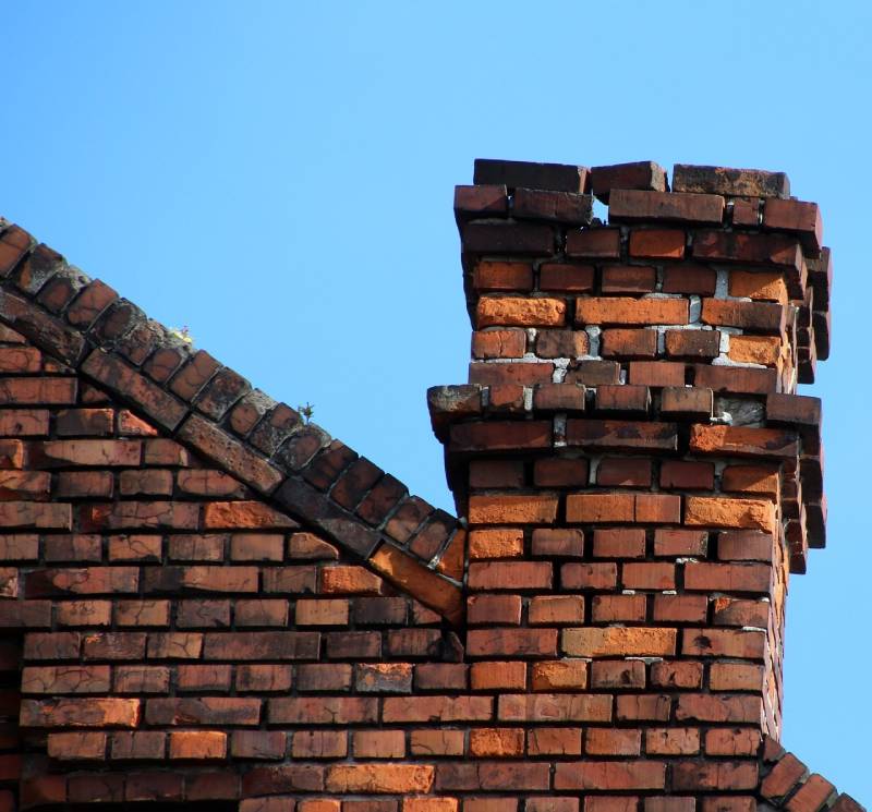 Damaged chimney on an Kingston home showing cracks and missing mortar
